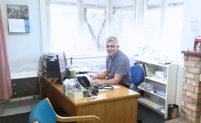Dr Gavin Lobo at his desk in the Mount Eden clinic